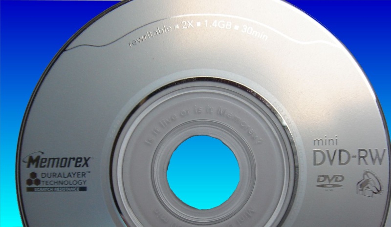 A Memorex dvd from a Canon DC210 camera that had the recording mode of disk error message. The disc is silver in colour with a purple dye recording layer.