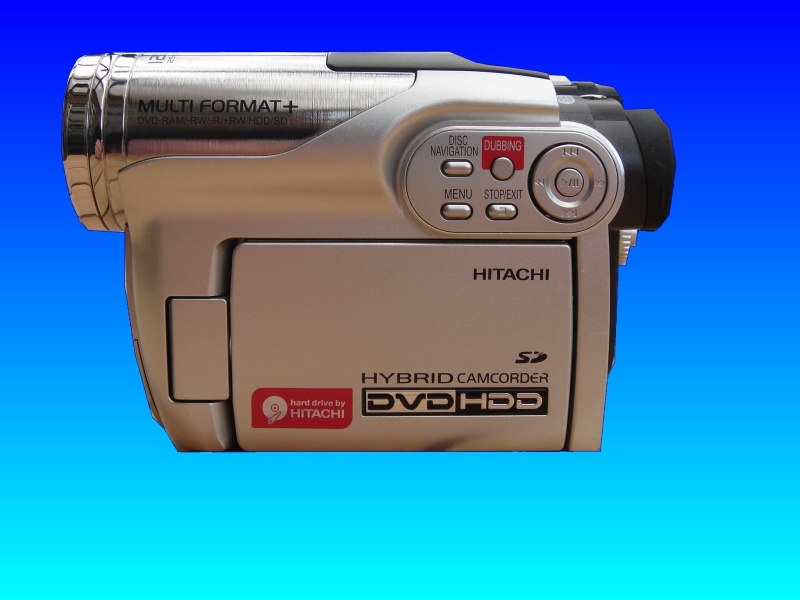 An Hitachi DZ-HS500E DVD HDD hybrid camcorder is pictured in the centre of the image against a blue background. The labels on the camera indicate it uses DVD-RAM disks and an internal hard drive storage for the video data.