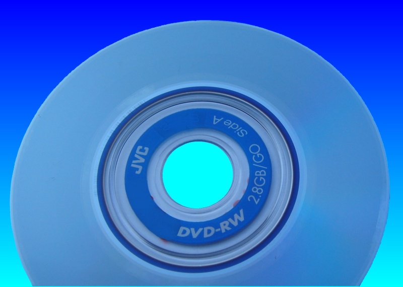 The photo is of a wedding DVD recorded to a JVC mini disc using a Sony Camcorder. The disk is pictured against a blue background and appears oval. In the centre of the disk is a marking showing 2.8gb double sided dvd-rw.