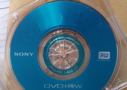A Sony DVD disk shown inserted in it's mini case. The 8cm disk is a blue DVD+RW and could not be finalised.