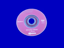 A pink Sony DVD-RW 8cm disk taken from a Sony Camcorder. The disc is shown against a blue background.